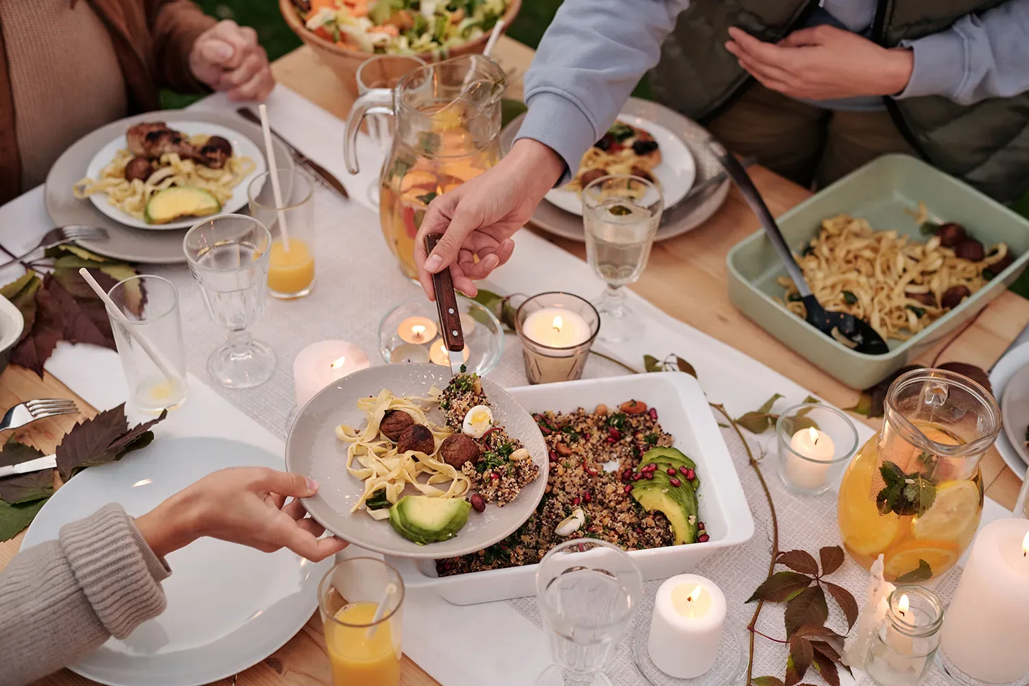Friends sharing dinner by candlelight