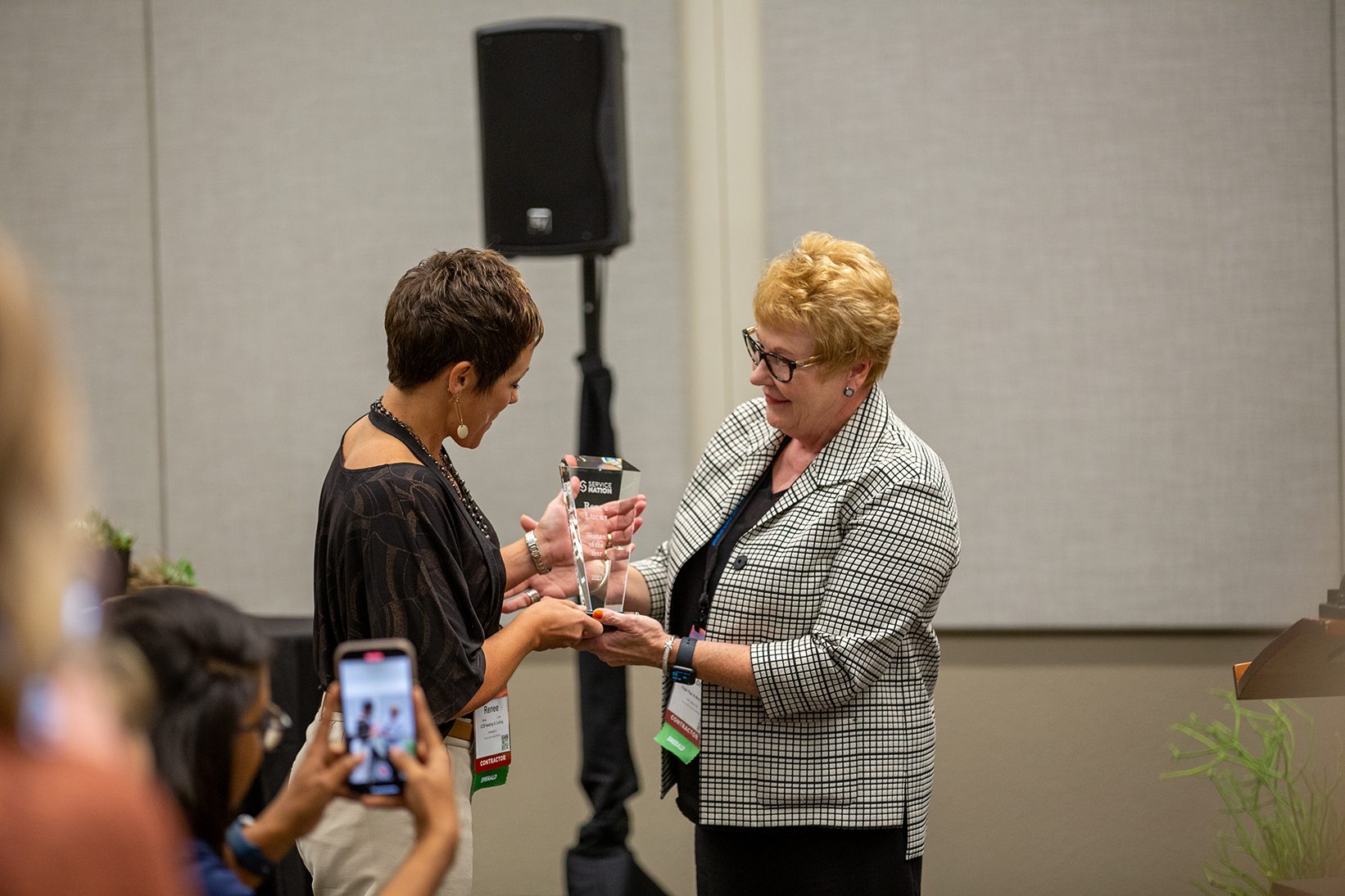 2022 recipient Lori Tschohl presenting the 2023 award to Renee Lucas